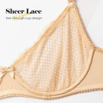 Close-up of a sheer lace bra with a see-through cup design, featuring delicate lace details and a small bow in the middle