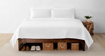 a bed with storage cubbies and sneakers under it