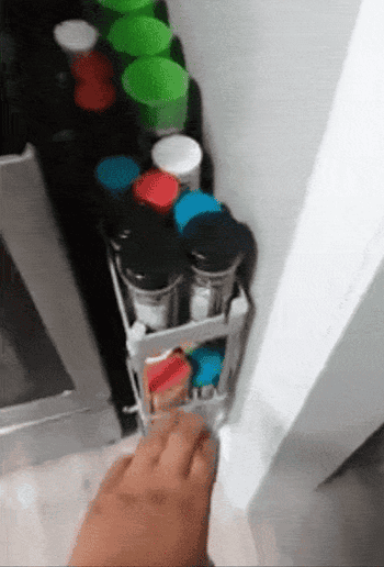 A reviewer gif of them sliding the cart out from next to the stove to reveal all the spices