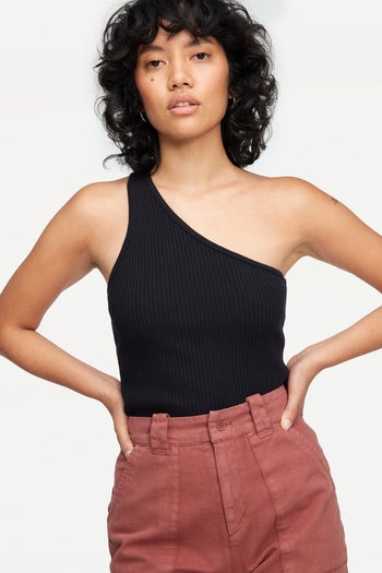 front view of a model wearing the one-shoulder tank in black