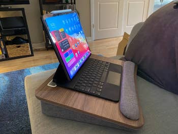 reviewer's laptop-style tablet setup with keyboard on a wooden lap desk, ideal for comfortable home shopping