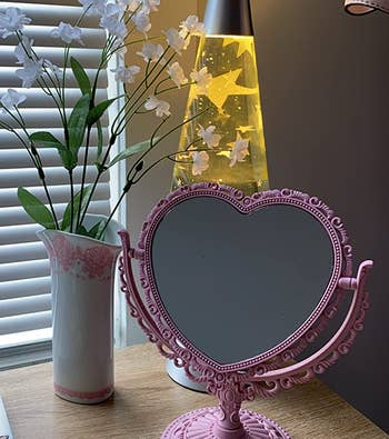 reviewer photo of the heart shaped mirror on a desk