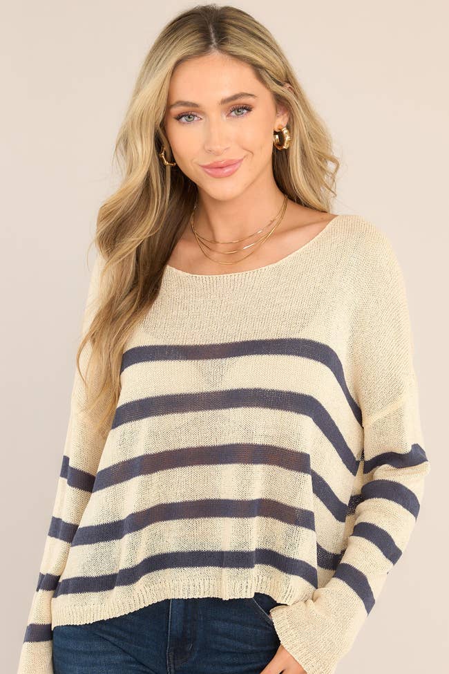 model in navy and beige striped pullover sweater