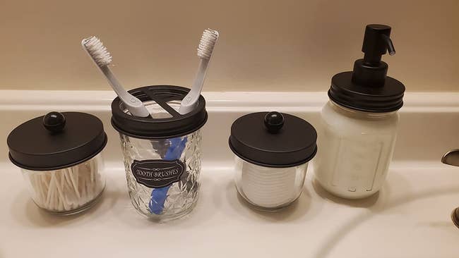 reviewer image of the set of four mason jar bathroom accessories