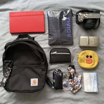 reviewer photo of mini Carhartt backpack with all its contents spread out