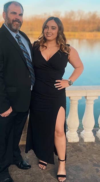 Image of reviewer wearing black dress standing next to someone