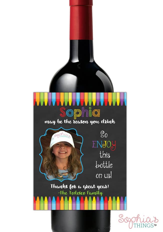 a wine label in front of a wine bottle  with a child's face on it that says 
