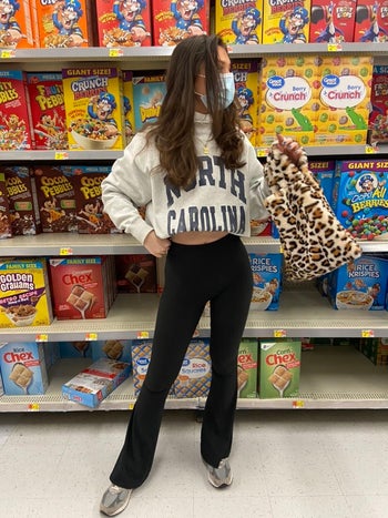 reviewer wearing the black leggings with a cropped sweater