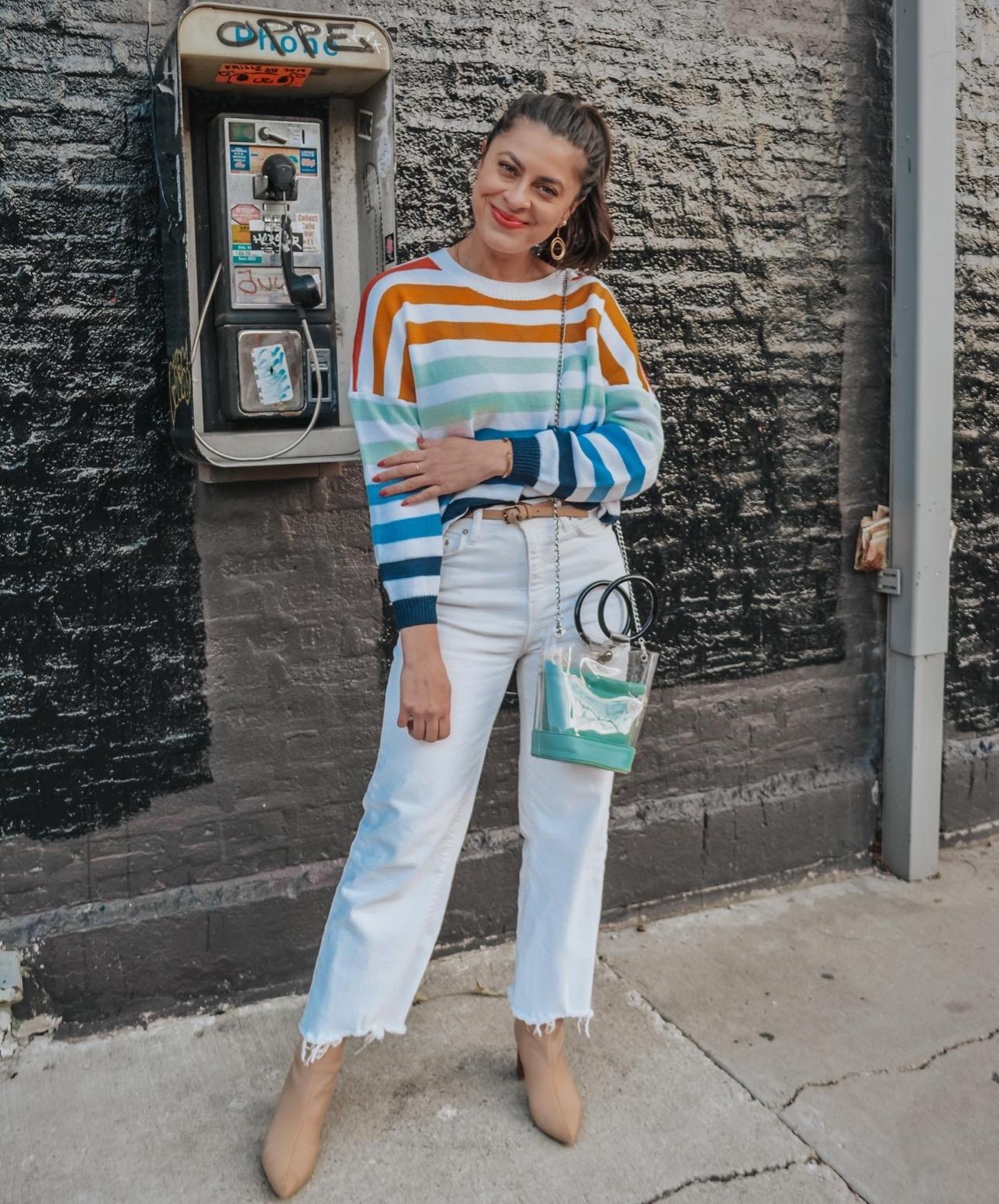 a reviewer in a rainbow striped sweater