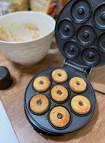 reviewer's donut maker with room for seven cookied mini donuts 