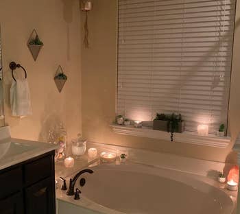 Reviewer photo of the holders with candles in them surrounding the bathtub