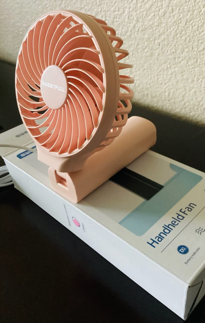Compact handheld instrumentality   connected  a box; portable and battery-powered plan  perfect  for on-the-go cooling
