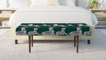 green zebra print bench at foot of bed