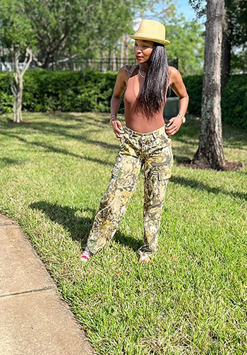 a reviewer wearing the green camo pants