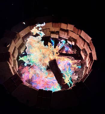 reviewer photo of colorful flames inside a fire pit