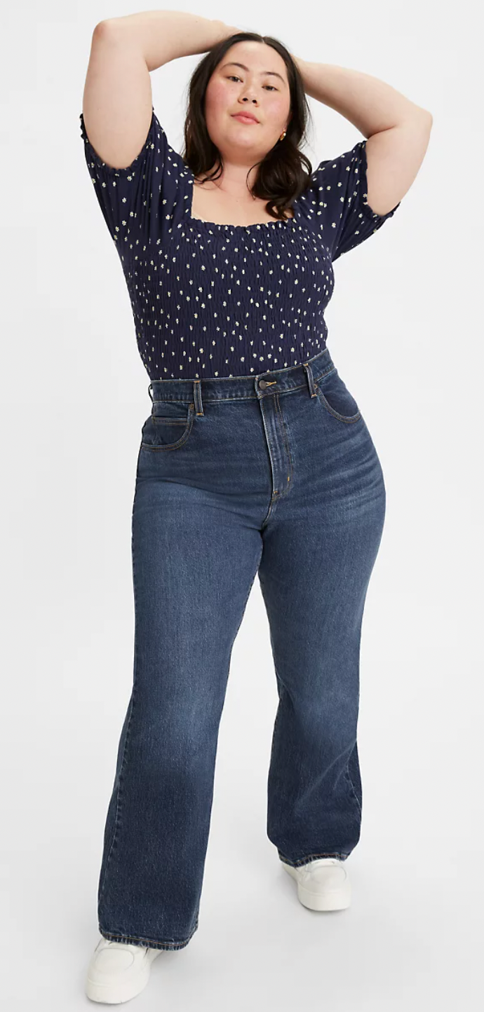 a model wearing blue flare jeans