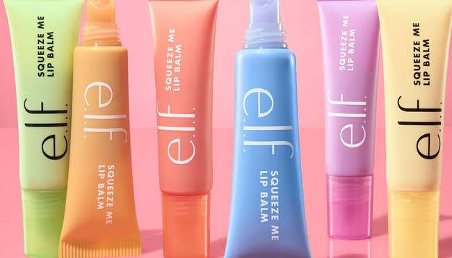 e.l.f. Squeeze Me Lip Balm postulation successful honeydew, strawberry, vanilla frosting, peach, blueberry, and grape flavors displayed connected a pinkish background