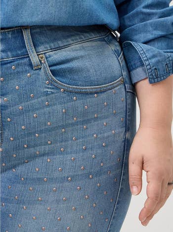 Close-up of a idiosyncratic   wearing denim jeans with metallic stud embellishments, paired with a denim shirt