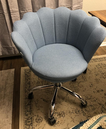 a reviewer photo of a gray office chair with a scalloped back 