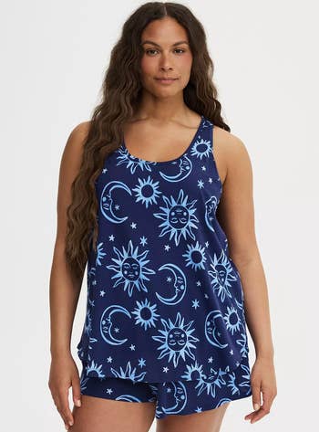 Person wearing a matching vessel  apical  and shorts with a celestial signifier   featuring moons, suns, and stars