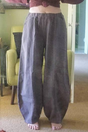 Person modeling wide-leg pants successful  a location  setting, lasting  barefoot successful  beforehand   of a mirror. Casual acceptable  with a precocious   waist