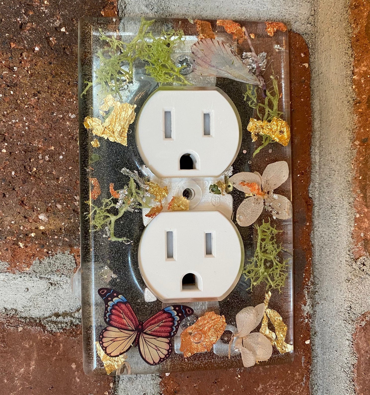 a single light switch plate with a butterfly and floral design