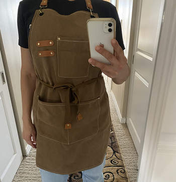 reviewer wearing the brown apron