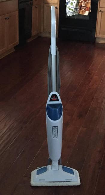Reviewer image of white and blue steam mop on hardwood floor