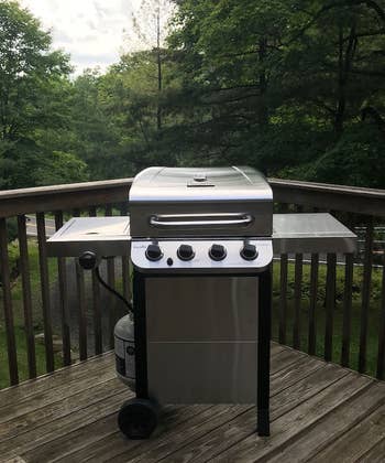 reviewer photo of the stainless steel grill on a deck