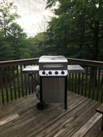 reviewer photo of the stainless steel grill on a deck