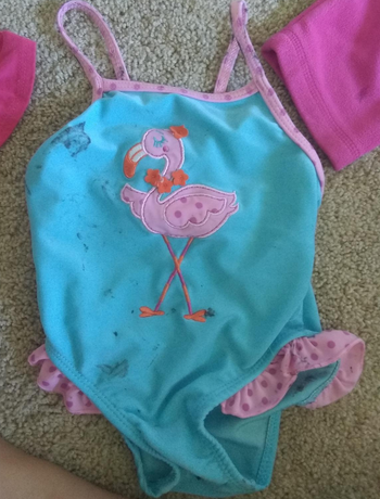 reviewer before photo of a child's bathing suit with stains on it