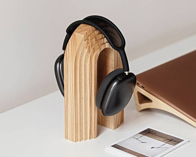 the ash wood holder with headphones on it