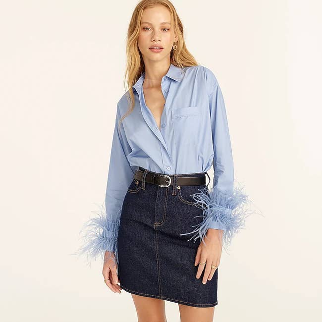 model wearing the feather-trim button down in blue