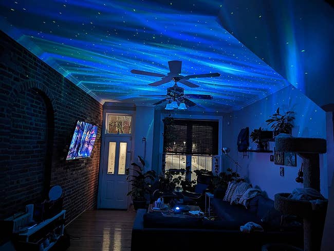 the galaxy light casting blue lights and stars on the ceiling