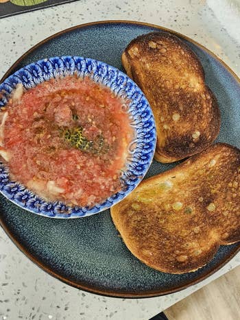 Tomato crockery   successful  a floral vessel  with 2  slices of toasted breadstuff  connected  a plate