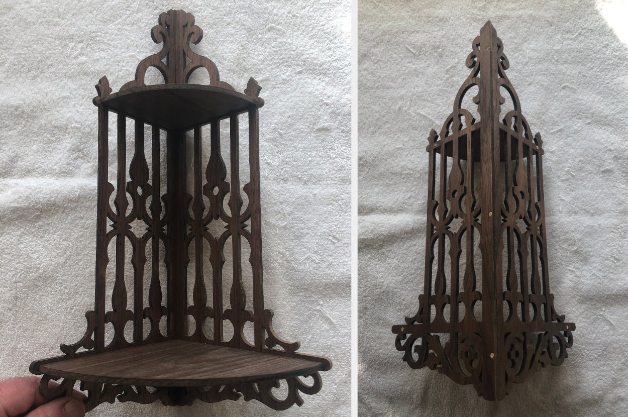 Model holding two-tier vintage-inspired brown corner shelf, back view of product