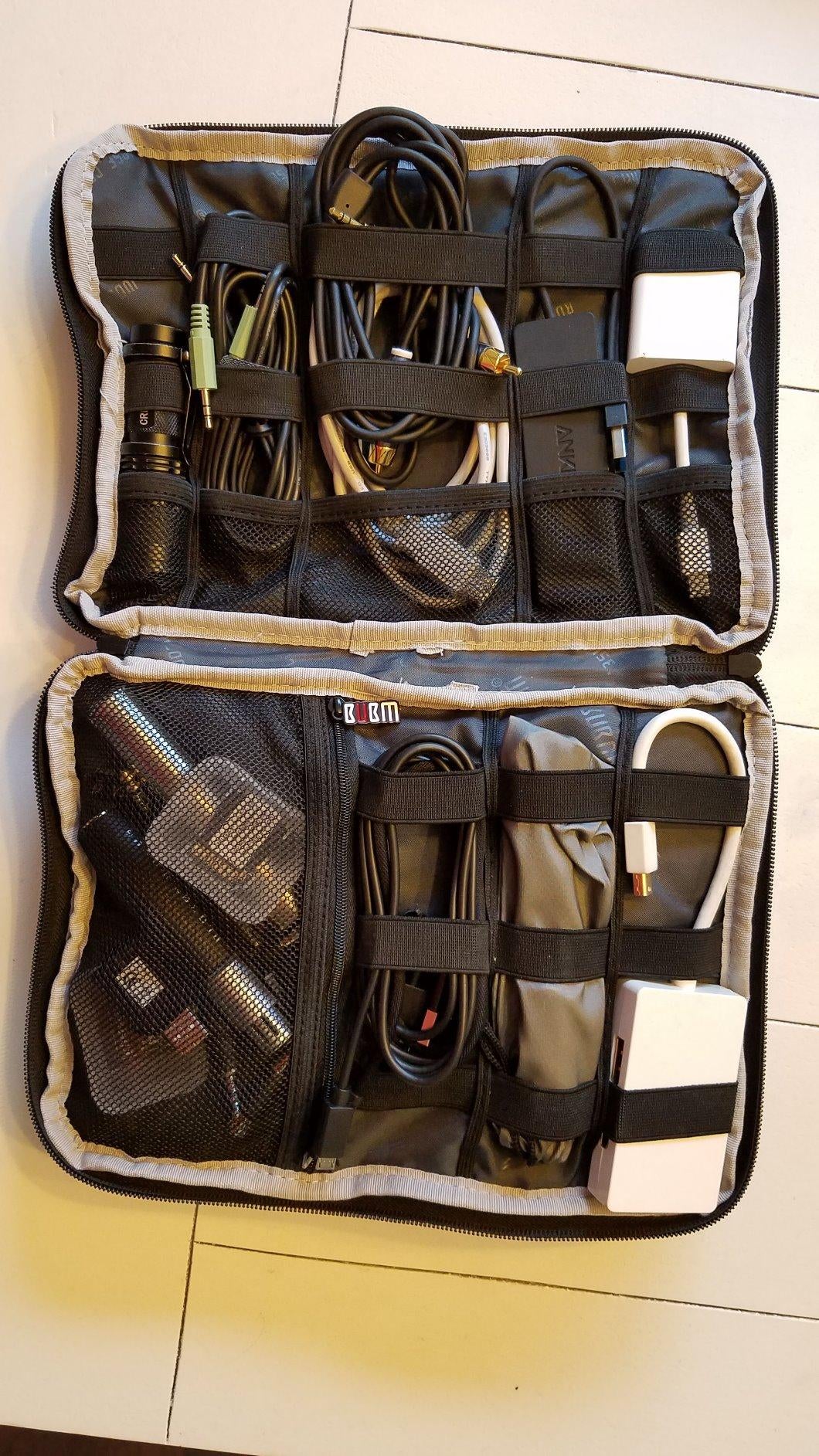 Reviewer's tech organizer filled with cables and chargers