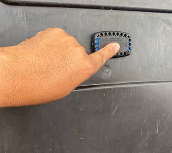 image of reviewer's hand placing guard on trash can