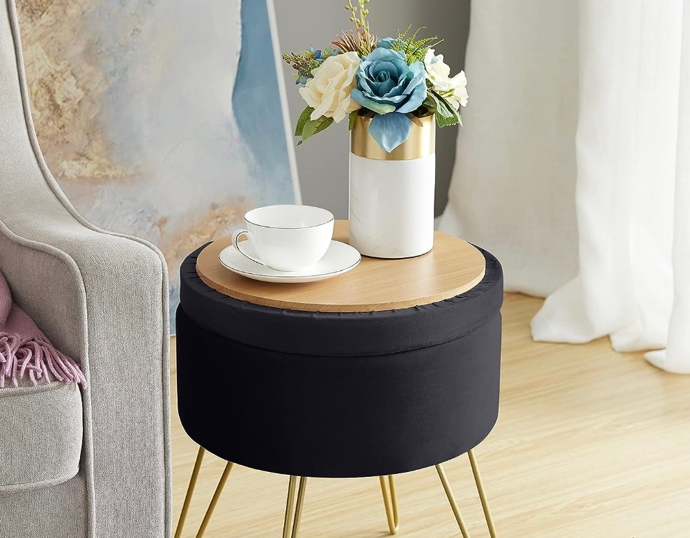 The black ottoman with the top flipped ever to show its tabletop