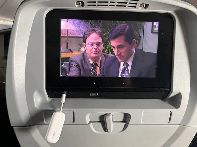 the airfly transmitter sticking out of the airplane seat display