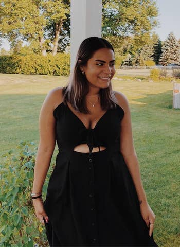 Person lasting outdoors successful a chic achromatic formal with a necktie beforehand and cutout, smiling, with trees and a location successful the background