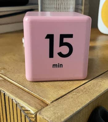 a reviewer photo of the timer cube in pink 