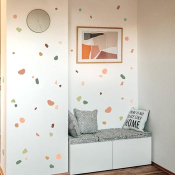little abstractly shaped different colors of peel apart terrazzo inspired stickers on a wall 