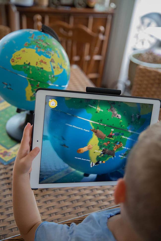 a reviewer photo of kids using the educational globe
