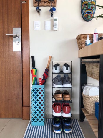 reviewer photo of small vertical shoe rack near entryway
