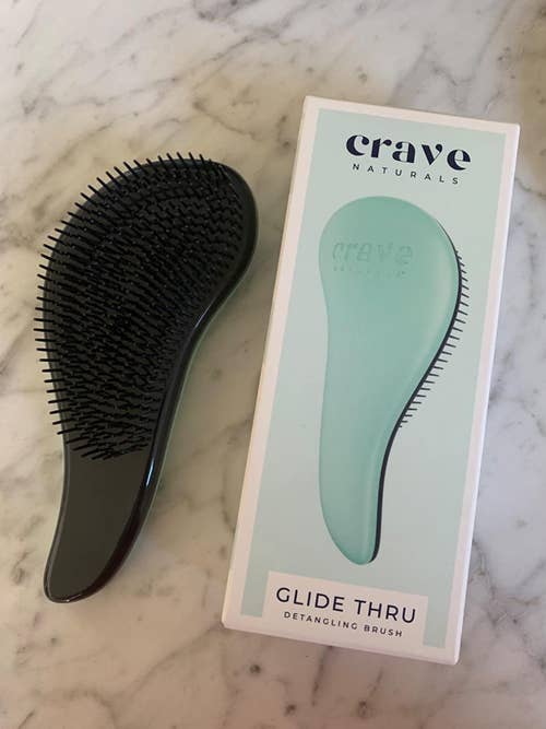 reviewer's photo of the ergonomic brush in teal