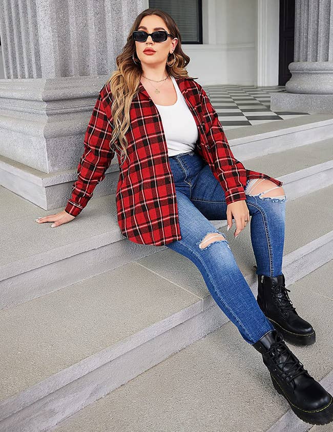 model wearing red flannel with distressed skinny jeans and combat boots