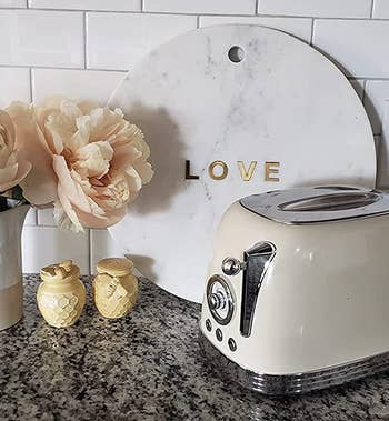 the cream colored toaster on a reviewer's counter