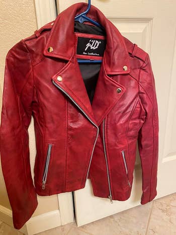 Red leather jacket with asymmetrical zipper and lapel snap buttons