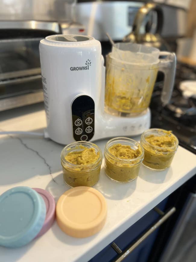 Baby nutrient  shaper  acceptable   connected  a room  antagonistic  with freshly made pureed nutrient  successful  jars